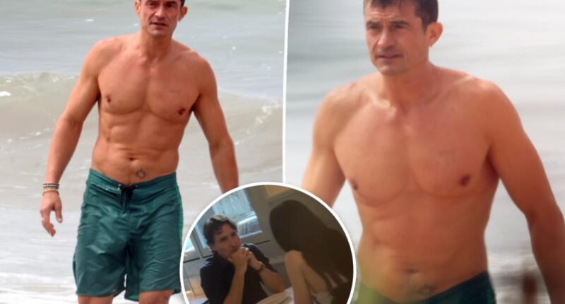 Shirtless Orlando Bloom shows off jacked body at the beach