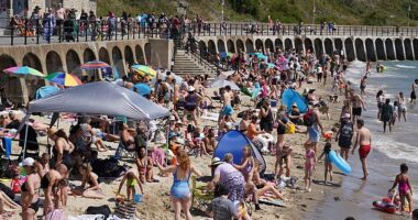 People enjoying the hot weather on Sunny Sands beach in Folkestone, Kent, on July 12