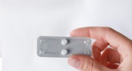 Hand holding pills