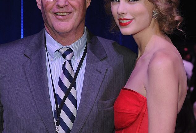 Taylor Swift's triumphant appearance on her boyfriend Travis Kelce's podcast took a somber turn as she shared a health update on her father Scott after he underwent 'intense' heart surgery; seen together in 2011 in Nashville, Tennessee