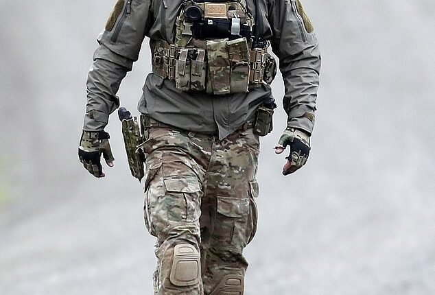 A Special Operations Group officer prepares to enter the wilderness to take down Freeman