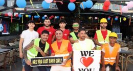 Turkish waiters in Caspers Bar, Marmaris, posing with signs beckoning women of all ages to come inside