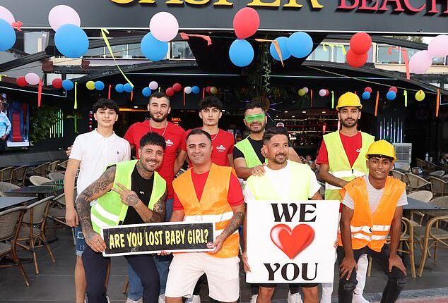 Turkish waiters in Caspers Bar, Marmaris, posing with signs beckoning women of all ages to come inside
