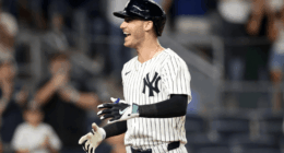 Cody Bellinger in Yankees pinstripes swings during a 2025 game, delivering another key hit in a breakout season.