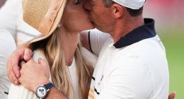 At the end of an emotional week, Rory McIlroy kisses his wife Erica at the Ryder Cup where Europe beat the US 15-13 on yet another extraordinary day of golf