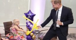 Prince Harry playfights using balloon swords with nine-year-old Gwen Foster