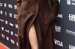 Angelina Jolie, 50, flashed her endless legs in a chic brown maxi coat split while attending the Couture world premiere during Toronto Film Festival on Sunday