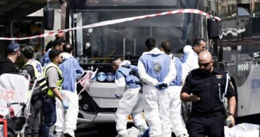 At least five killed and 12 injured after gunmen open fire at bus stop in Jerusalem