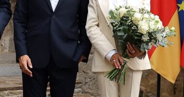 Emmanuel (L) and Brigitte Macron (R) with German Chancellor Friedrich Merz (out of shot) at the Fort de Bregancon in France, August 28, 2025