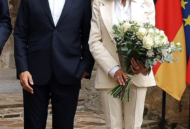 Emmanuel (L) and Brigitte Macron (R) with German Chancellor Friedrich Merz (out of shot) at the Fort de Bregancon in France, August 28, 2025