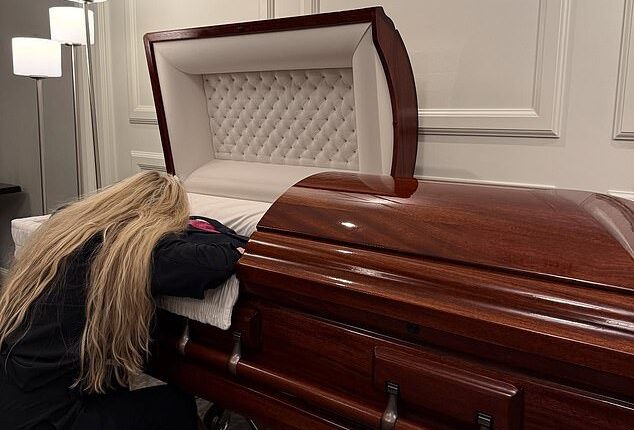 Erike Kirk, the wife of the late Charlie Kirk, appears to be collapsed in grief as she lies draped across her husband's casket