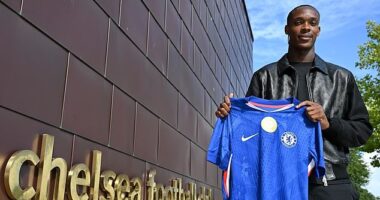 Emanuel Emegha poses with a Chelsea shirt at their Cobham training ground