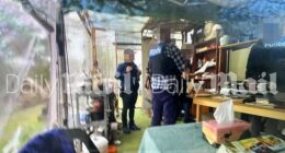 Victoria Police officers are seen in the makeshift kitchen attached to Dezi Freeman's bus as they try to serve him a warrant linked to allegations of historical sex assault on a minor