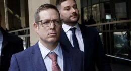 Sergeant James Fitzgerald (front) and Constable Alexander Papanastassis leave the Melbourne Magistrates' Court on Friday