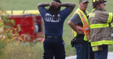 A first responder at the scene with his hands over his head as the incident unfolds