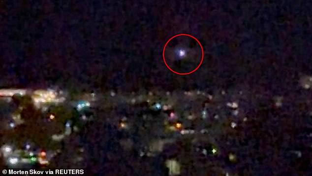 A light moves in the sky over Aalborg, amid reports of drone sightings that led to the airport being closed for several hours on Thursday