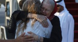 Barbie Reynolds hugs her daughter Sarah Entwistle after landing at the airport in Doha on September 19, 2025