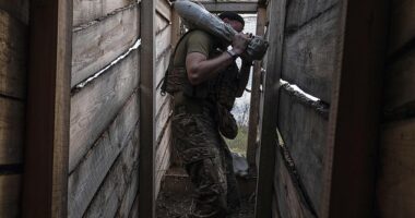 A soldier carries a shell to fire towards positions of Russian troops near Kostyantynivka in Donetsk region, Ukraine, Tuesday, Aug. 26, 2025
