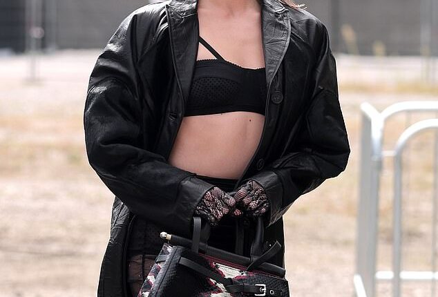 Clara McGregor flashed her abs in a skimpy black bra and a leather trench as she led the front row at Antonio Marras' Spring/Summer 2026 show during Milan Fashion Week on Wednesday