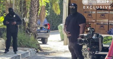 Two masked men were caught on video pacing outside the Hollywood Hills rental home vacated by D4vd on Wednesday