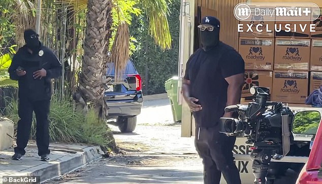 Two masked men were caught on video pacing outside the Hollywood Hills rental home vacated by D4vd on Wednesday