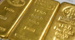 Gold prices hit all-time high on rising uncertainty, while U.S. stock futures little changed