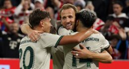 Harry Kane, pictured after scoring one of his two goals in a 4-0 win over Hoffenheim on Friday, insists he is happy at Bayern Munich