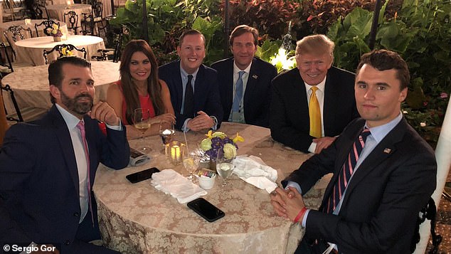Charlie Kirk (pictured, right) was like a 'adopted son' to the President and 'little brother' to Donald Trump Jr. He has dinner with them here at Mar-a-Lago in 2019