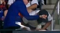 The older fan, in blue, and the younger fan, in white, are seen scrambling for the ball