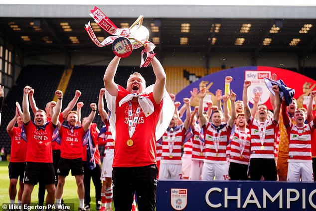 Doncaster boss 'Super' Grant McCann leads the celebrations after his team clinched the League Two title back in May