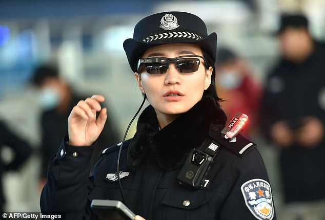 This photo taken on February 5, 2018 shows a police officer wearing a pair of smartglasses with a facial recognition system at Zhengzhou East Railway Station in Zhengzhou in China's central Henan province