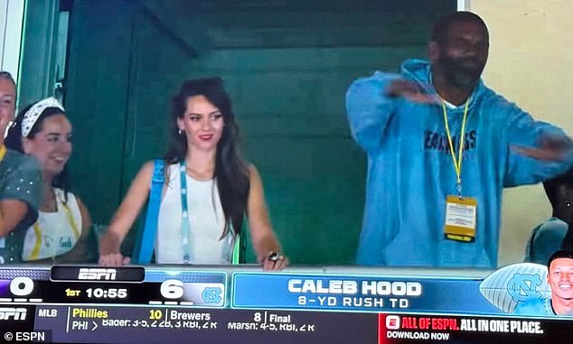 Hudson made her first appearance Monday as ESPN cameras caught her alongside Randy Moss, one of Belichick's favorite former players, after the Tar Heels scored on the opening drive to go up 6-0 on Texas Christian (TCU)
