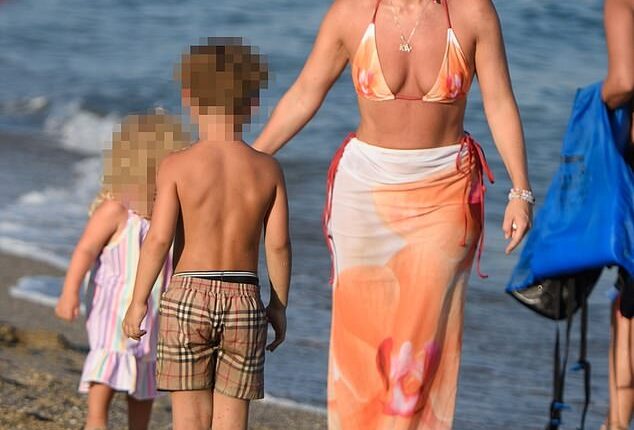 Lauryn Goodman showed off her toned figure during a fun-filled family holiday with her two children in Marbella on Tuesday