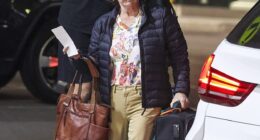 Julie Goodwin, 54, looked slender as ever on Sunday as she touched down at Sydney Airport with her husband-of-30-years Michael on Sunday night (both pictured)