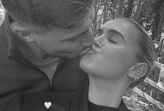 Molly-Mae Hague and Tommy Fury shared a kiss as they posed for loved-up snaps during a family day out on Monday