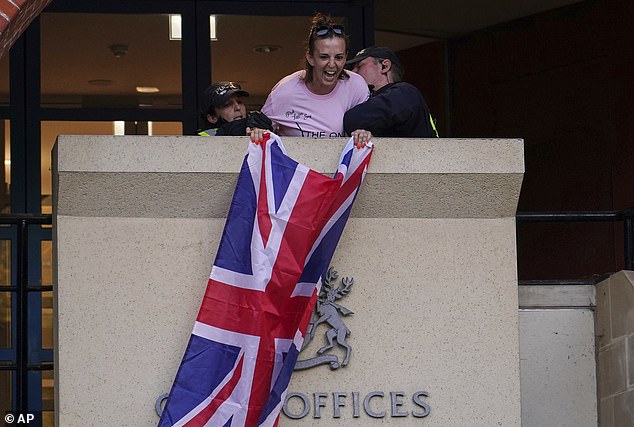 Footage shows a woman holding the flag above an entrance to Epping District Council's Civic Centre at 7.15pm yesterday.