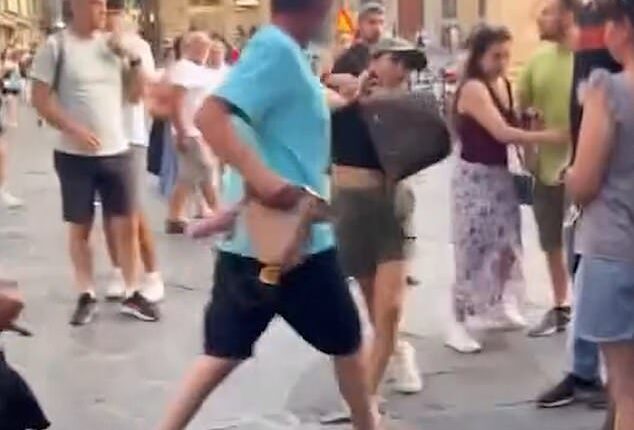 A 'pregnant' pickpocket was grabbed by the hair and prevented from running away as she tried to steal a tourist's backpack in Italy
