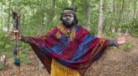 Self-styled ‘King Atehene' with his face smeared with ash from the fire and cowrie shells on his feathered headdress