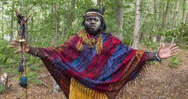 Self-styled ‘King Atehene' with his face smeared with ash from the fire and cowrie shells on his feathered headdress