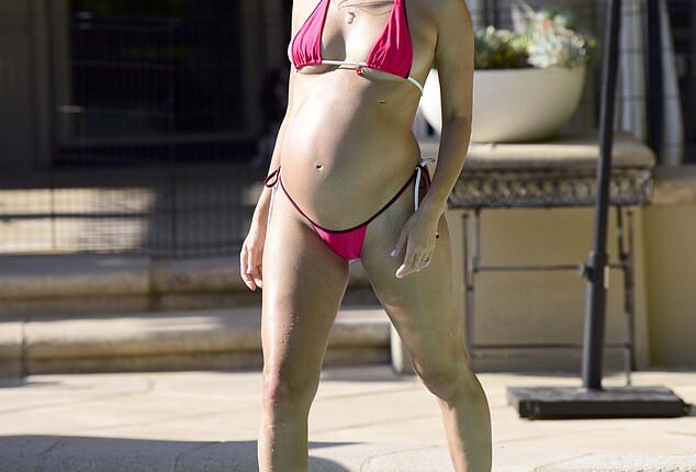 Joy Corrigan, 37,  seemed to enjoy flaunting her growing baby bump on Monday during a getaway in Palm Springs