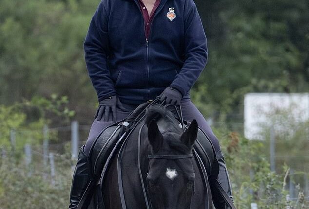 Prince Andrew (pictured) appeared to be grinning when he was photographed while horse riding in Windsor Great Park on Saturday