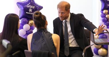 Prince Harry revealed what he and Meghan have been watching on Netflix together - but awkwardly failed to mention her show. Pictured speaking with 13-year-old Grace Tutt