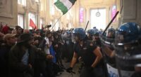 Protesters clash with anti-riot police at Milano Centrale train station on the sidelines of a nationwide strike organized by the Unione Sindacale di Base