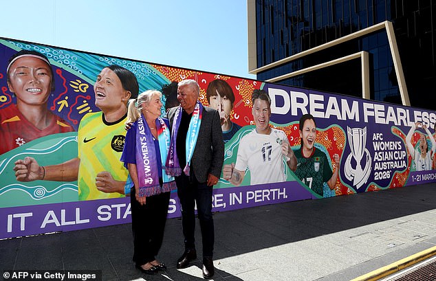 Sam Kerr's parents Roxanne and Roger (pictured in front of a mural featuring their daughter in Perth) feared for her future in football as her battle with a knee injury dragged on