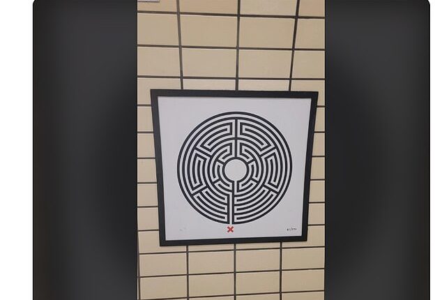 A curious London tourist snapped a photo of a circular, black-and-white maze-like image on the wall at Piccadilly Circus station, and appealed to the internet for answers