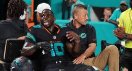 Miami Dolphins wide receiver Tyreek Hill (10) talks with a staff member after his injury