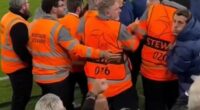 The Atletico Madrid member of staff (right) was caught on camera 'spitting' towards Liverpool fans