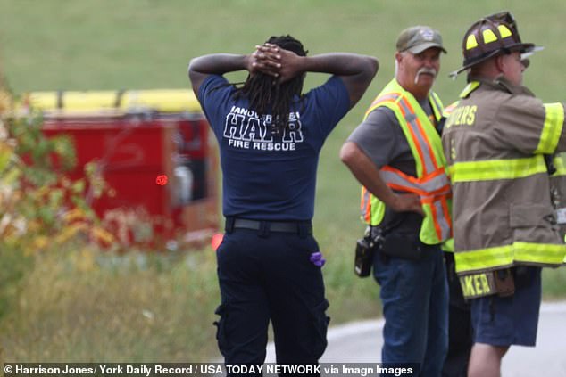A firefighter at the scene with his hands over his head as the incident unfolds in York County