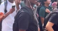 A Texas State University student (front, in black t-shirt) has been met with calls for his expulsion after he repeatedly reenacted Charlie Kirk's assassination at an on-campus memorial held in the conservative activist's honor