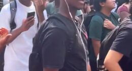 A Texas State University student (front, in black t-shirt) has been met with calls for his expulsion after he repeatedly reenacted Charlie Kirk's assassination at an on-campus memorial held in the conservative activist's honor